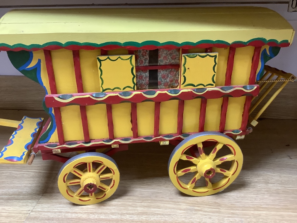 A large painted wood model Gypsy caravan and ceramic horse, overall length 85cm